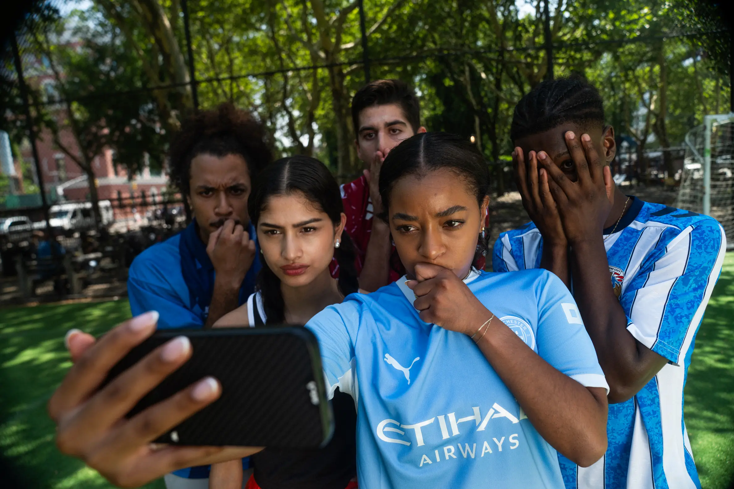Football fans taking a group selfie.