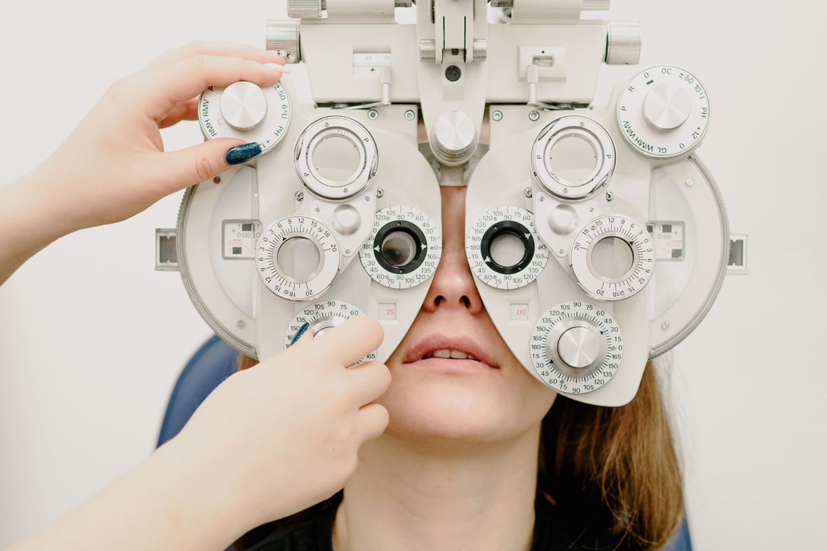 Adult patient undergoing a vision assessment with a phoropter
