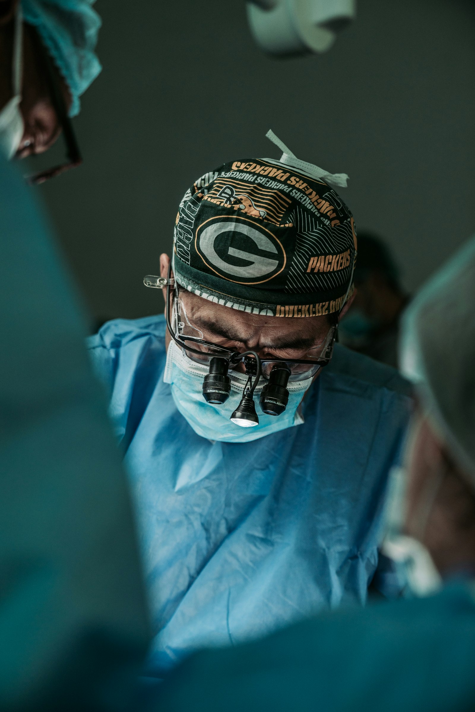 Surgeon wearing magnifying loupes · illustrative photo