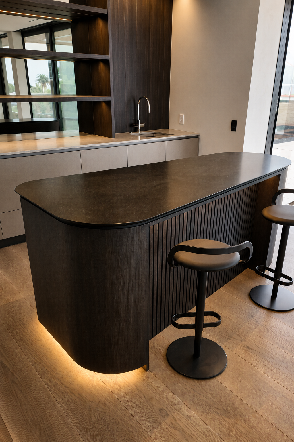 Curved dark timber bar joinery with ribbed detailing at Mauao Residence