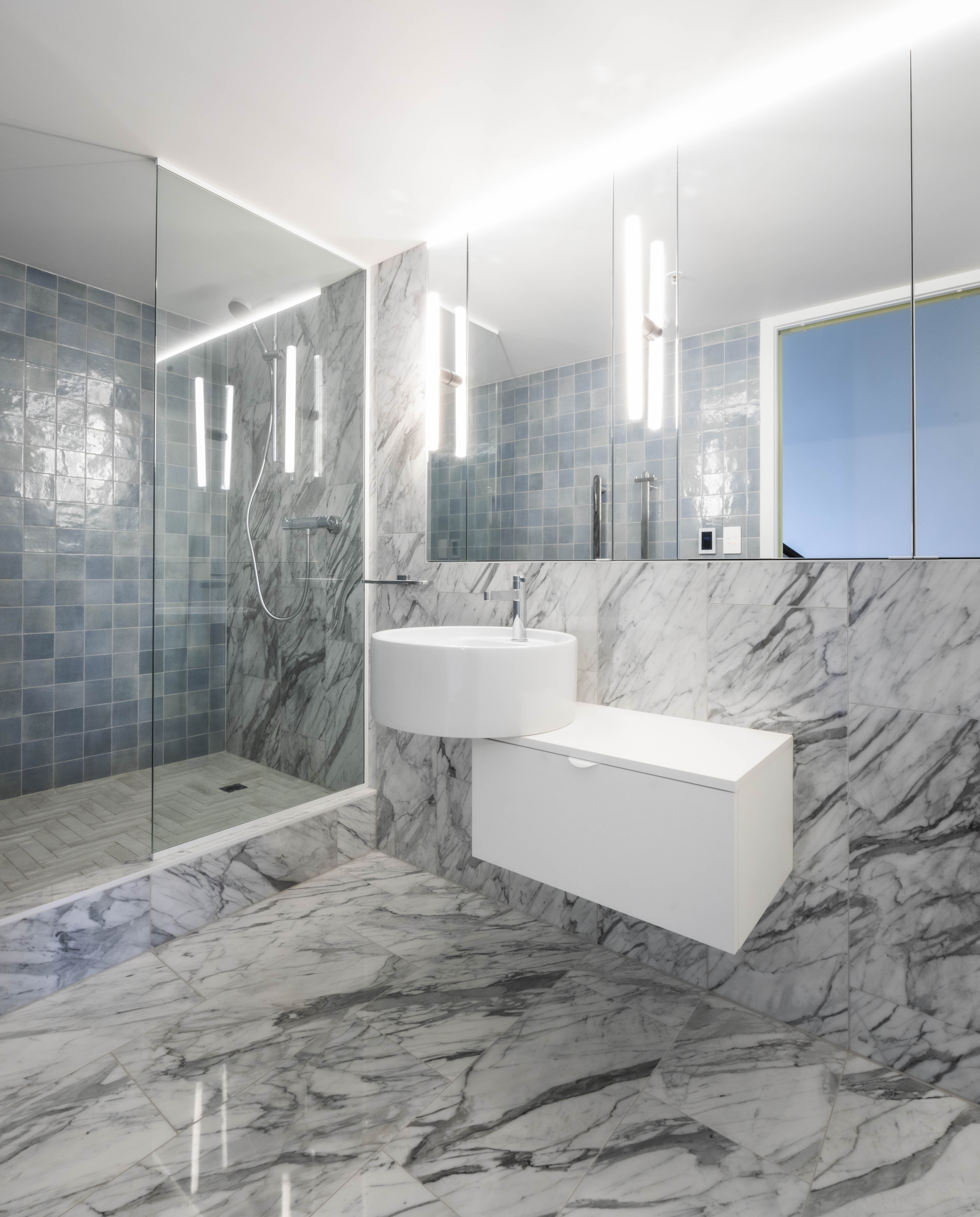 Custom bathroom vanity and marble-lined interior at George Court Apartment