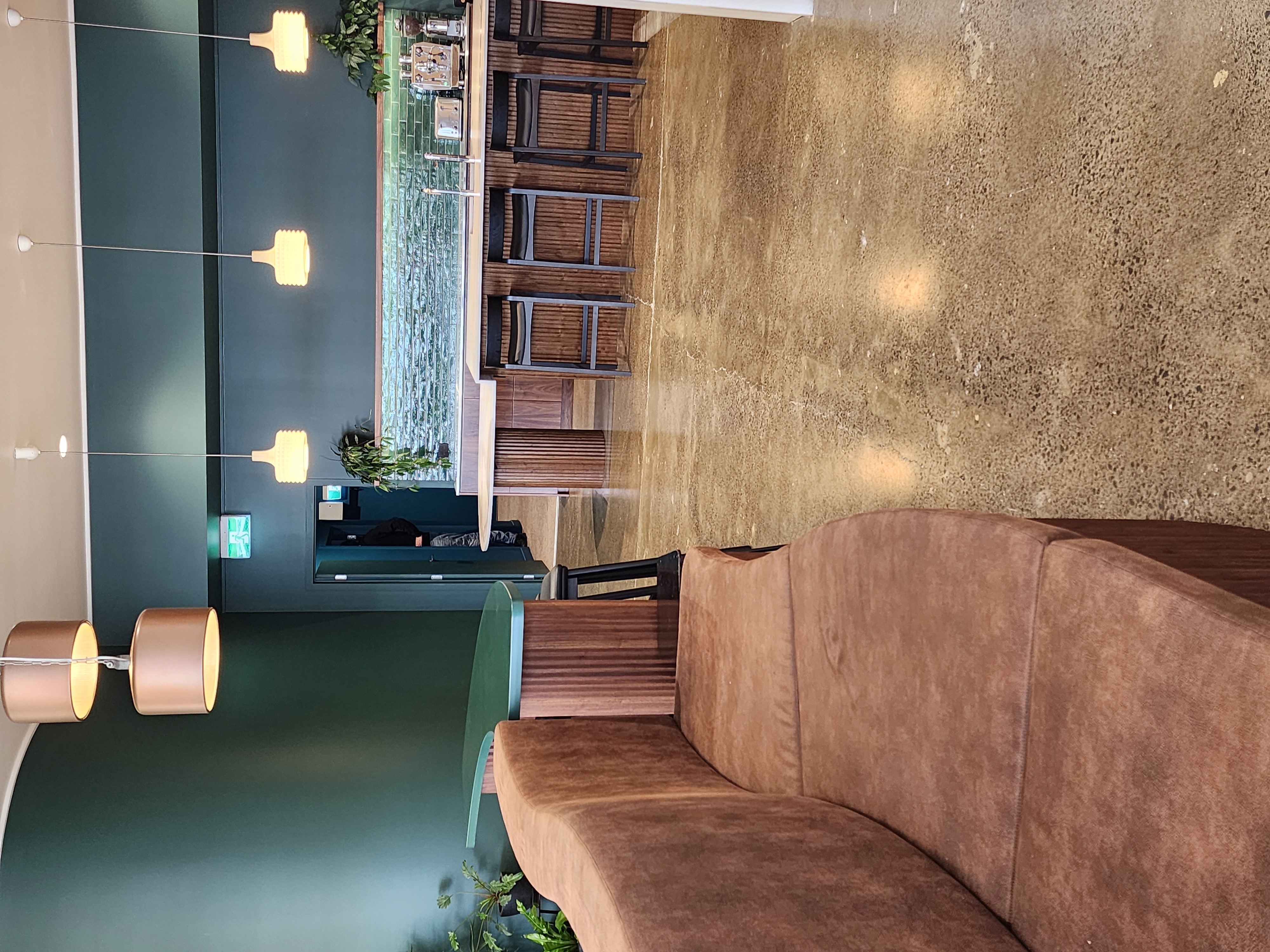 Finch Office breakout area with curved banquette, island seating and timber-grain kitchen cabinetry