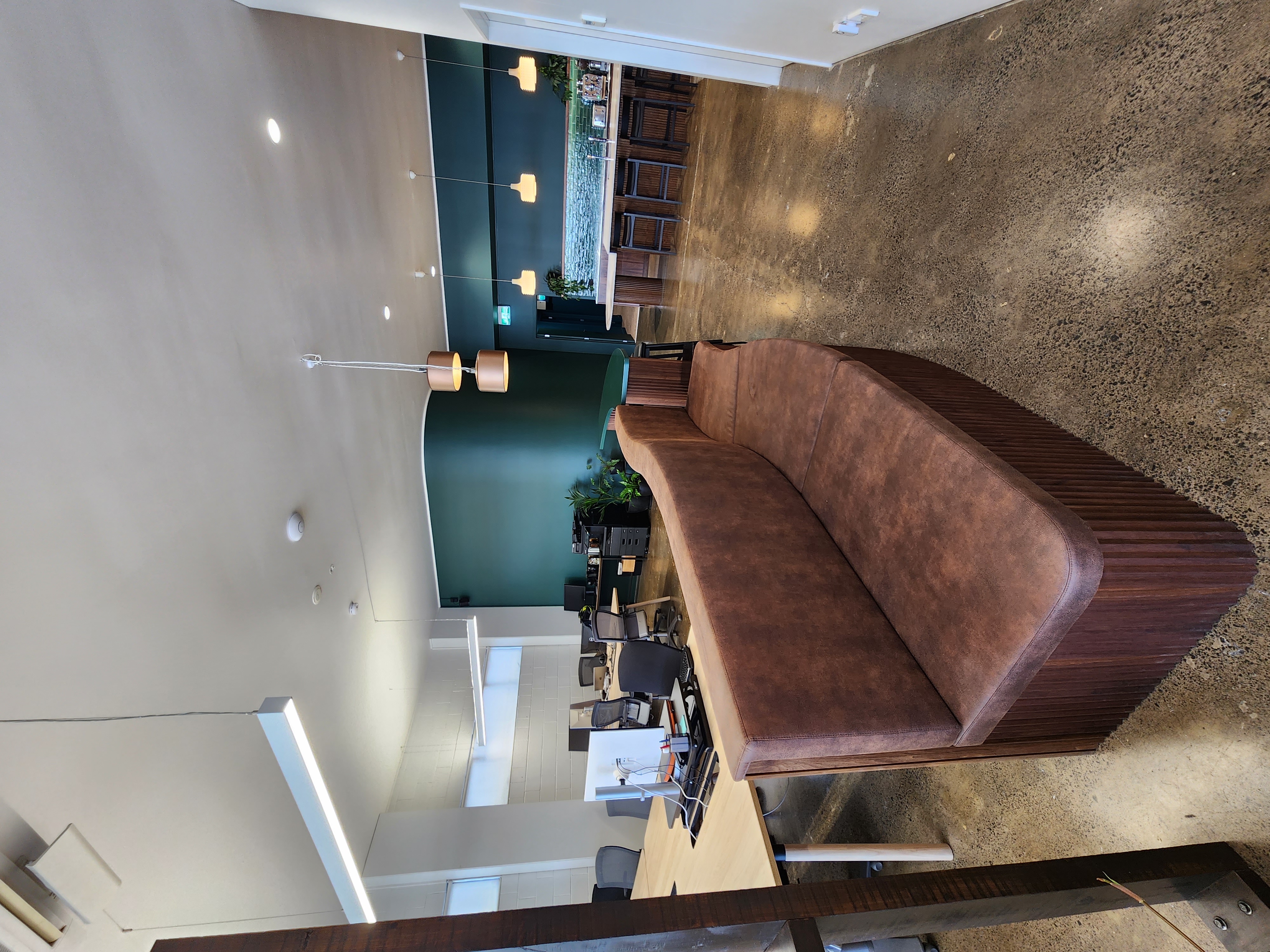 Curved timber-grain banquette seating in the Finch Office breakout area