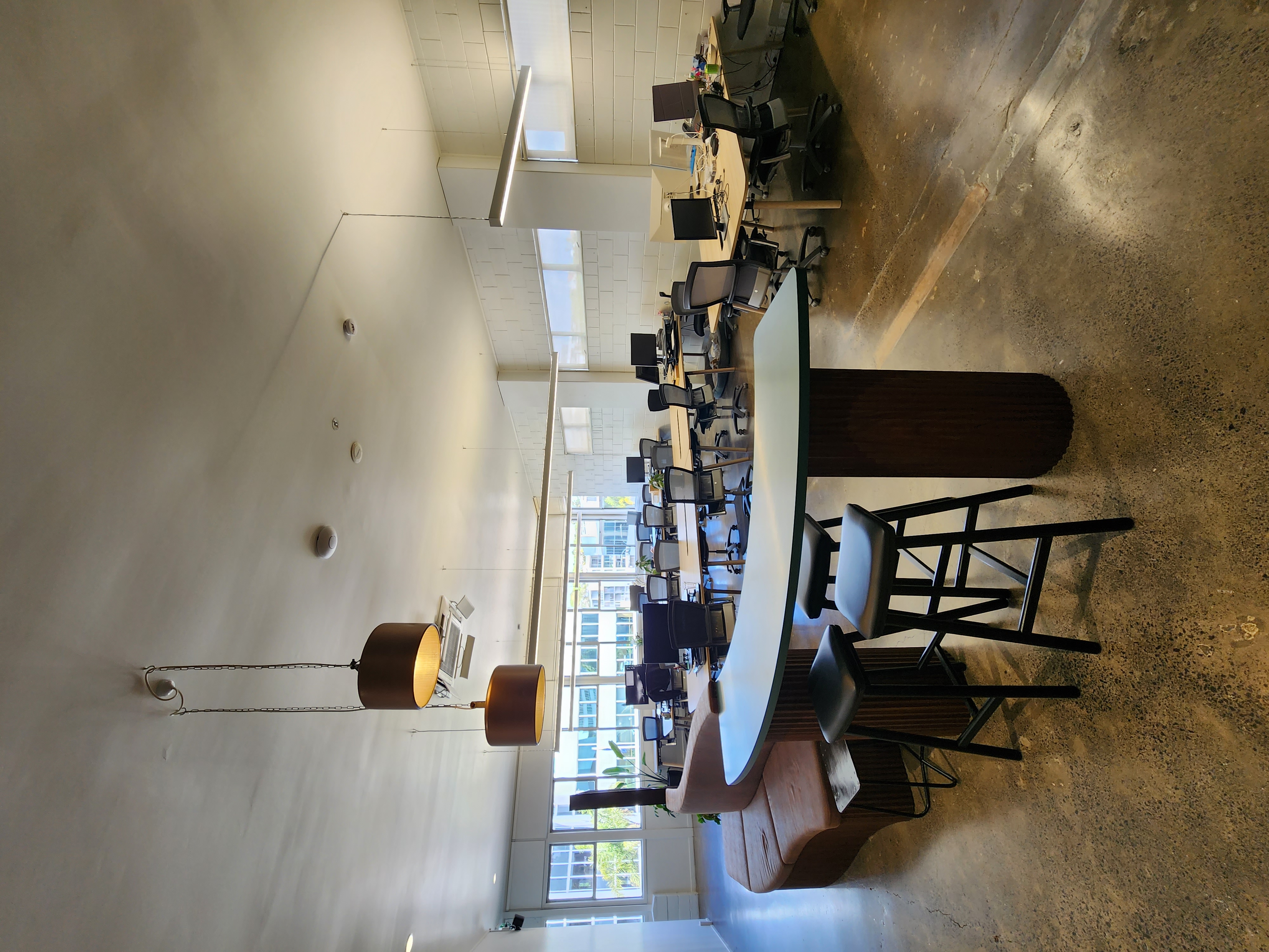 Open-plan Finch Office workspace with curved communal table and integrated banquette seating