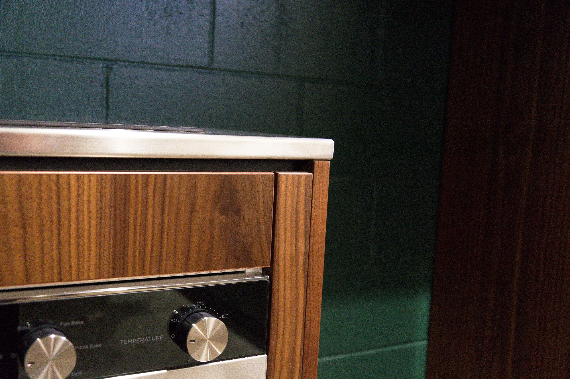 Close-up of timber-grain cabinetry around the built-in oven at Finch Office