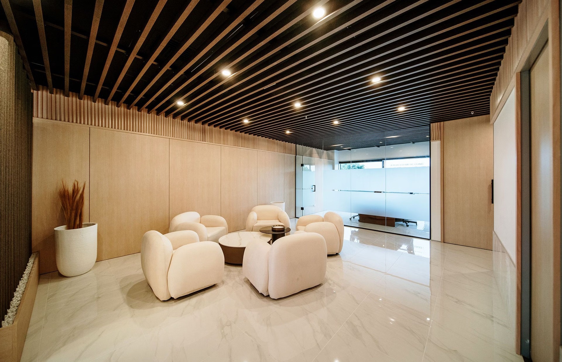 A+ Cosmetic Clinic waiting area with full-height timber wall panelling and dark slatted feature ceiling