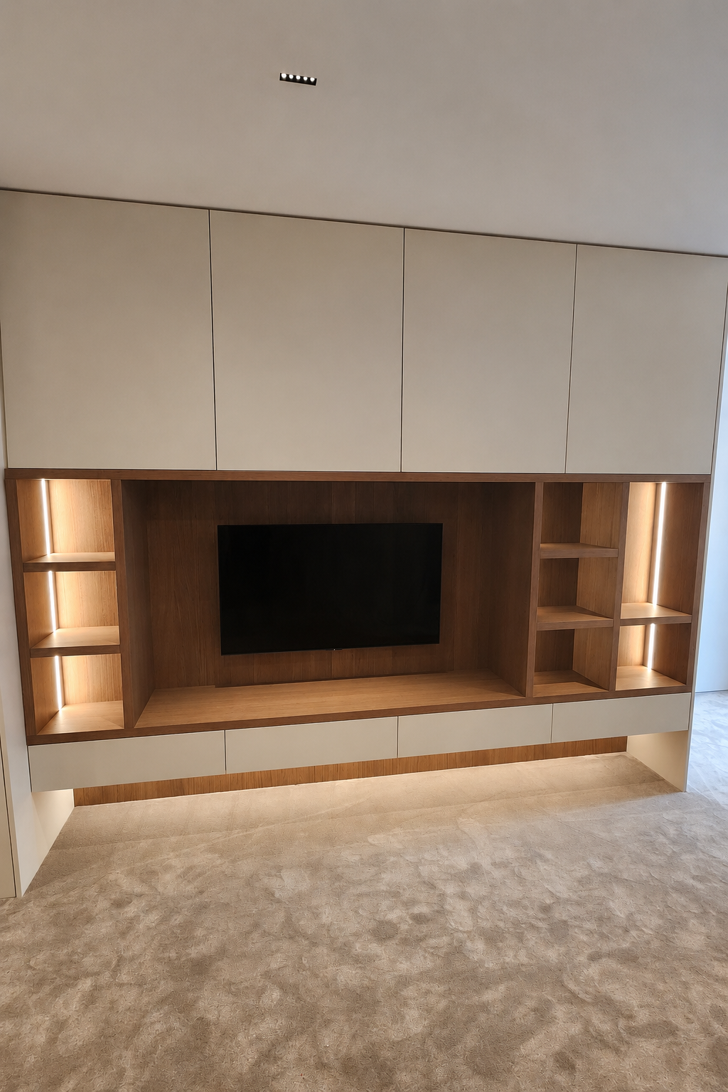 Full bedroom wardrobe and integrated TV cabinetry at Mauao Residence
