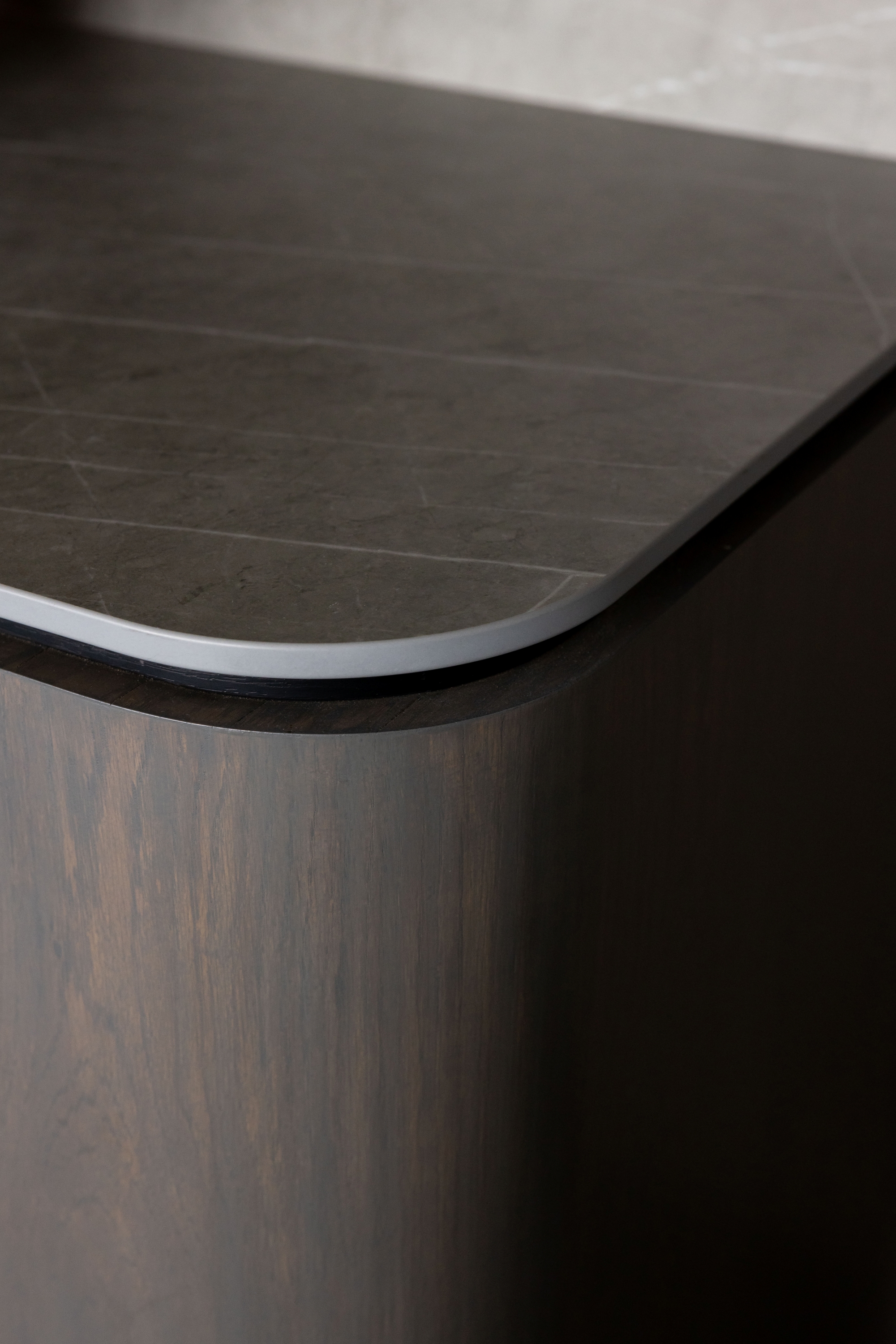 Curved timber cabinetry and stone worktop junction detail at Russell McVeagh Offices