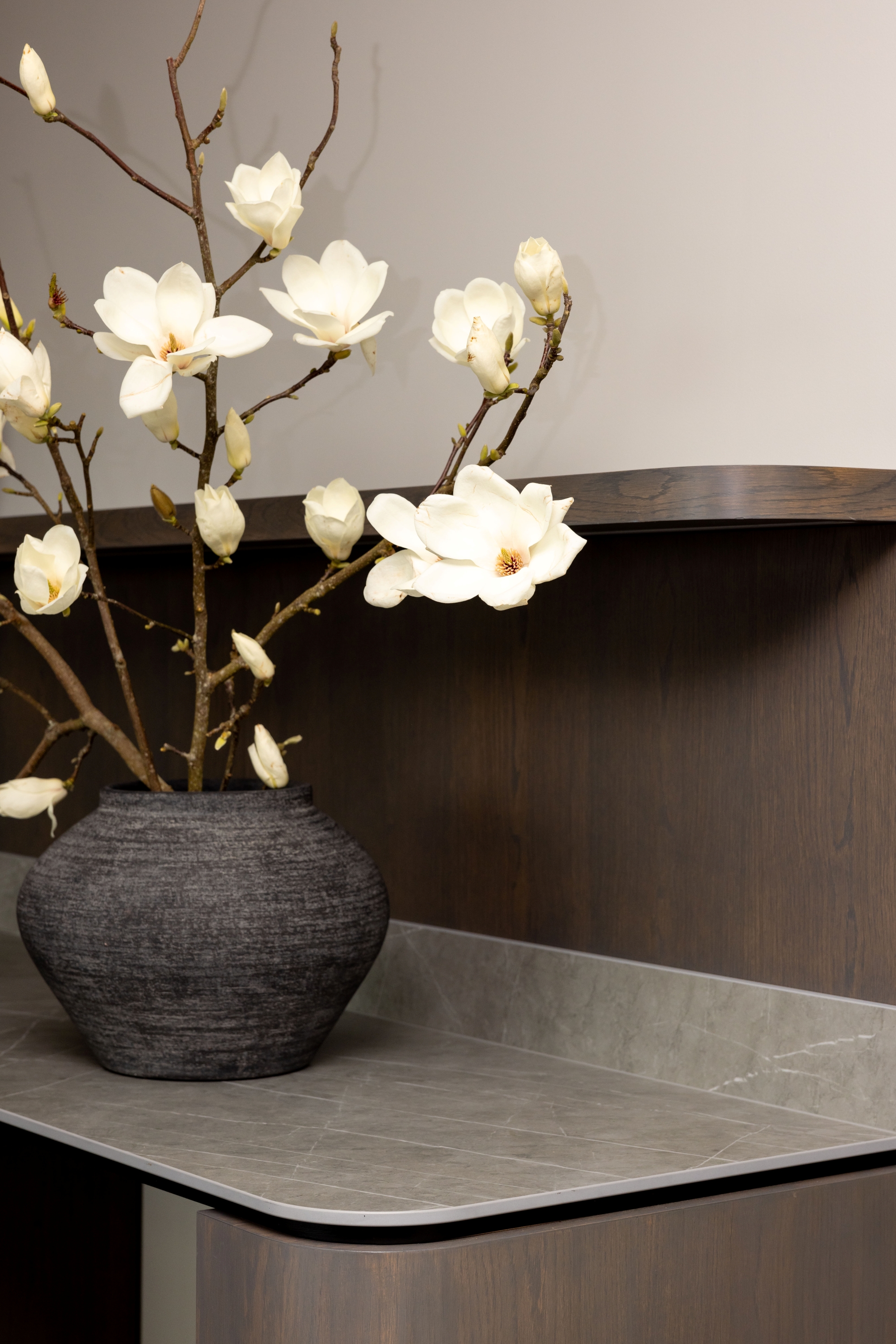 Illuminated meeting-room cabinetry with curved timber return at Russell McVeagh Offices