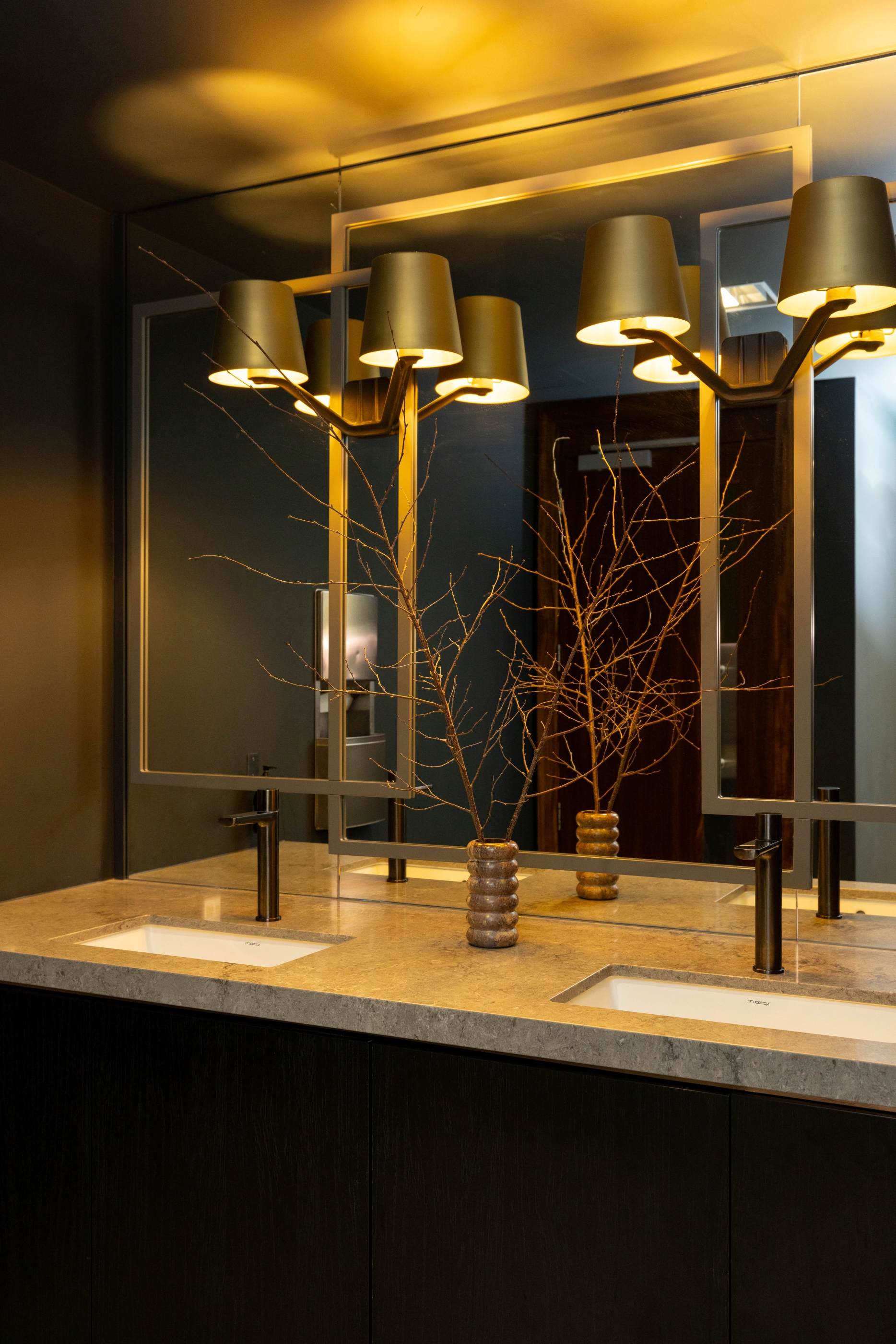 Custom bathroom vanity with timber cabinetry, stone top and mirror lighting at Russell McVeagh Offices