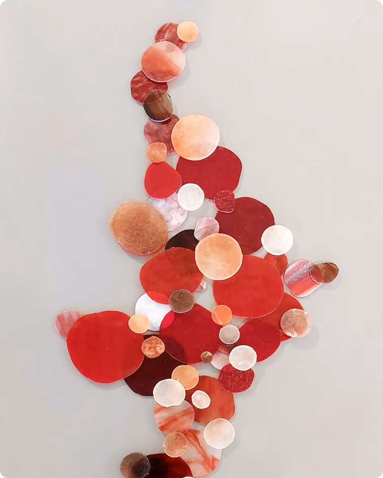 Circles in shades of red, pink, and brown arranged vertically on a light gray background.