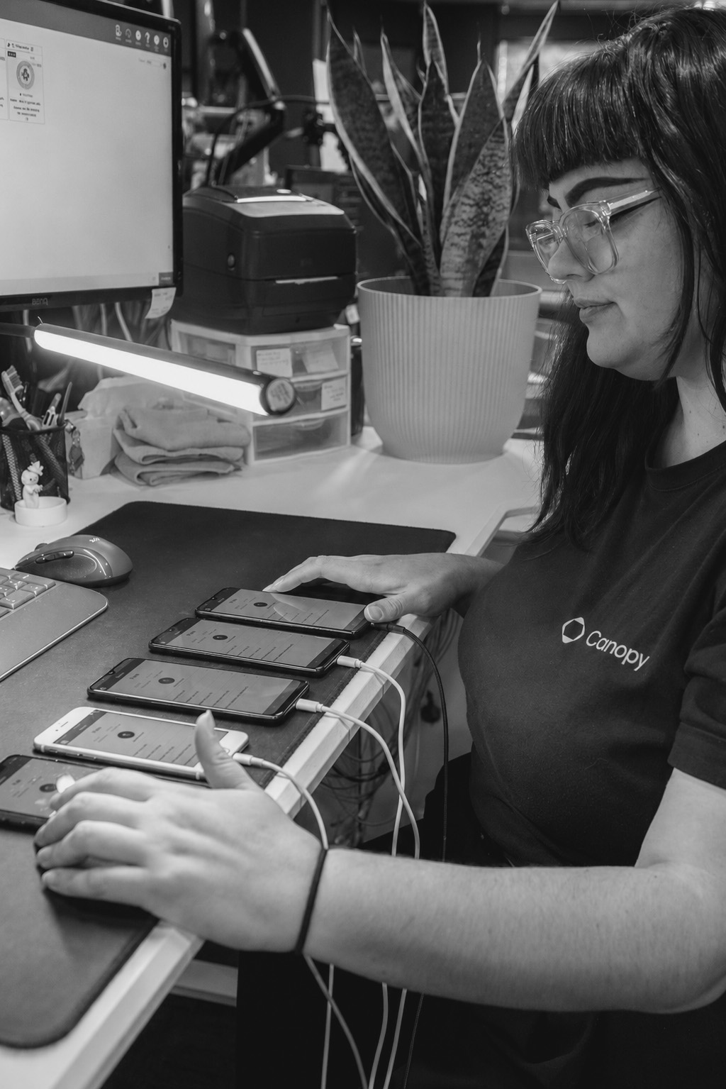 Canopy team member processing a row of connected smartphones for data erasure.