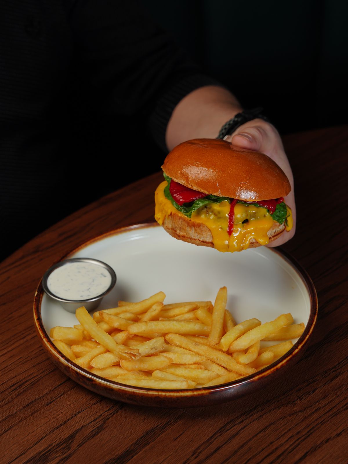 Placeholder stock photo of a cheeseburger with fries (temporary — to be replaced with approved ARIYA photography)