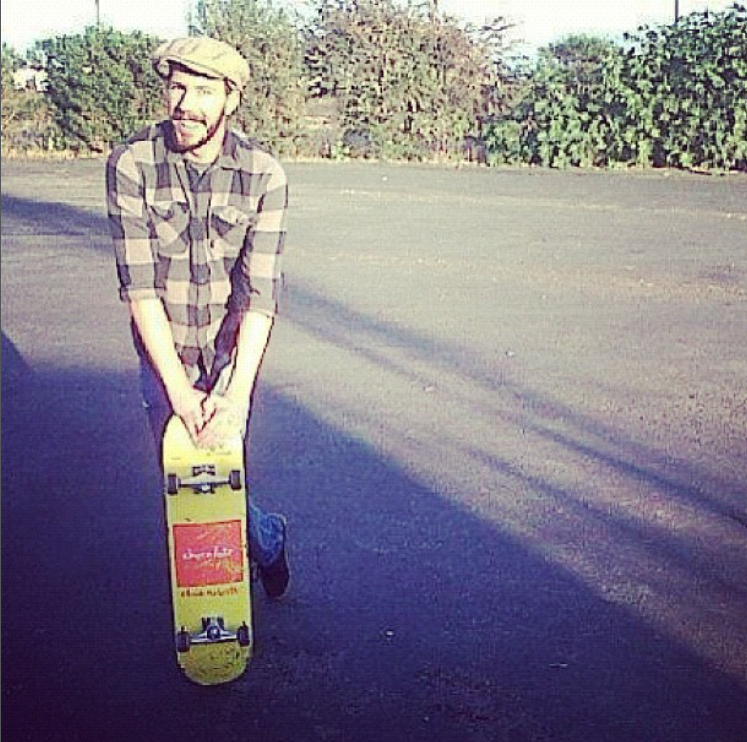 Founder skateboarding with his dog.