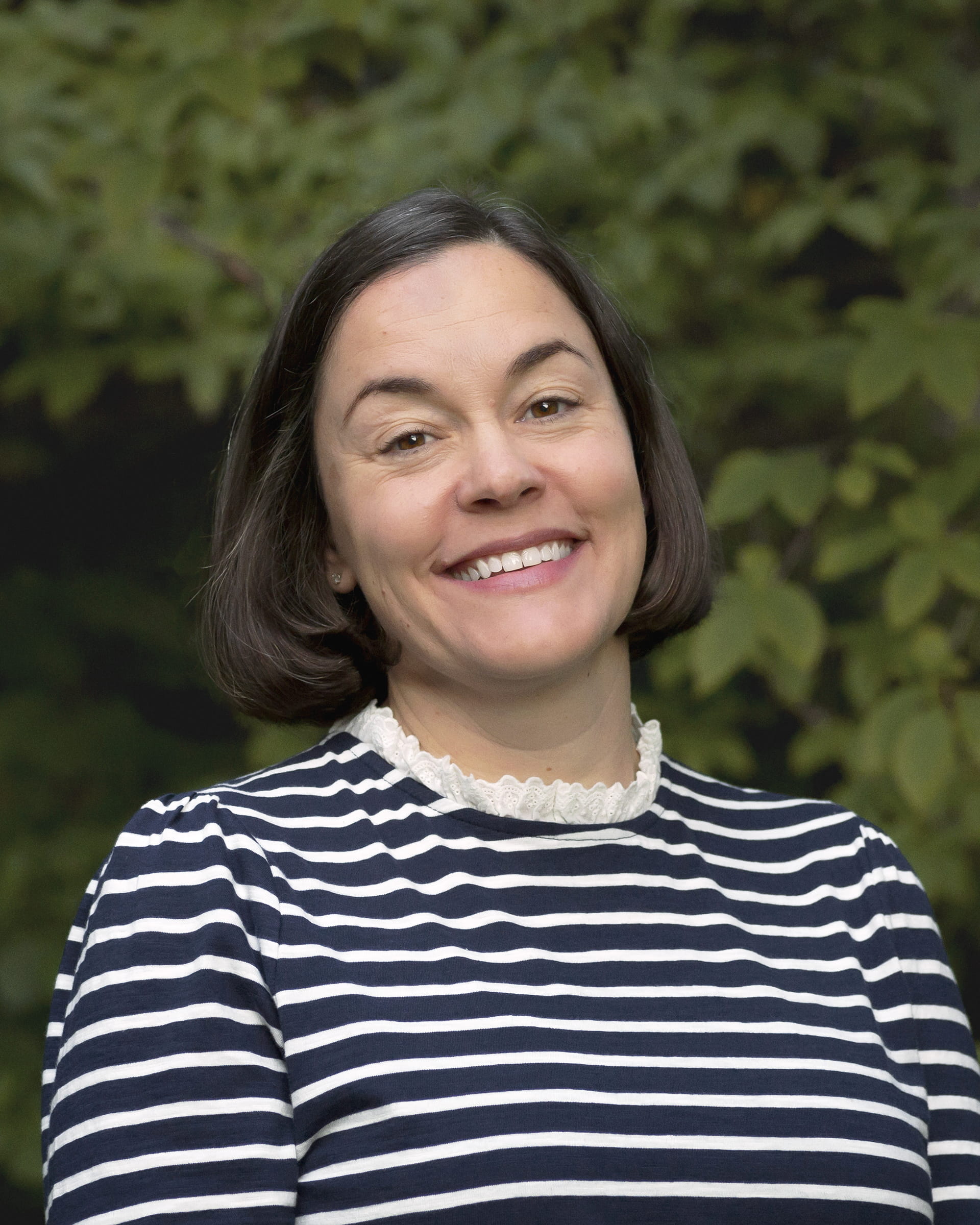 Brie Pio, founder and lead financial planner at Birch Point Wealth Management, smiling outdoors