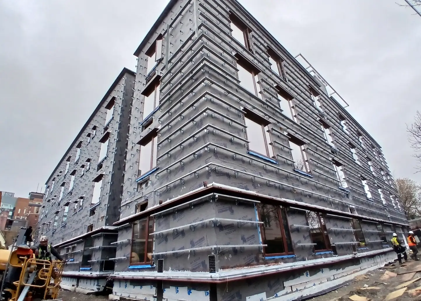 Continuous Z-girt support system installed over exterior air barrier, providing cladding attachment points and space for continuous insulation.
