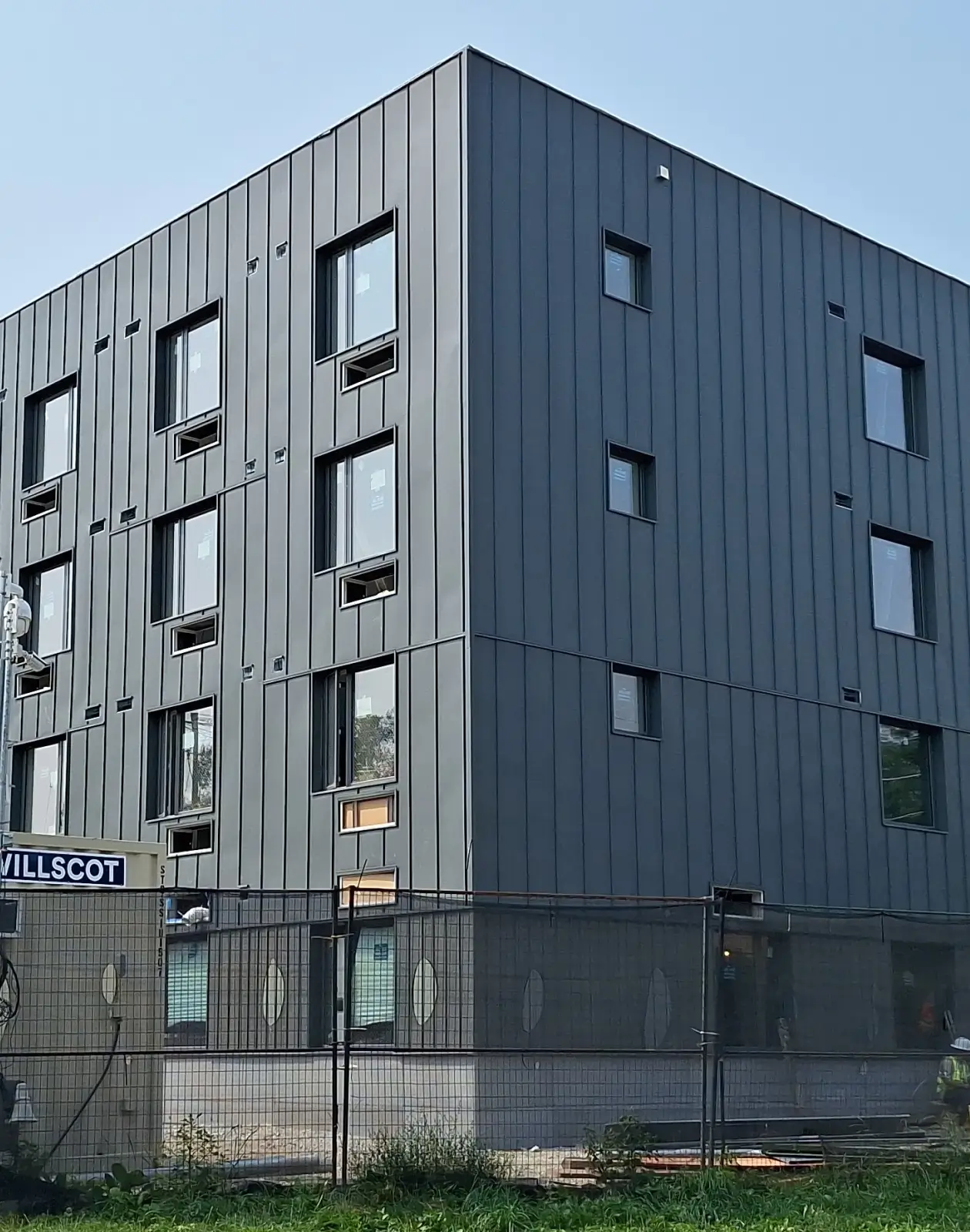 Metal siding system installed on a commercial building, providing a durable, low-maintenance exterior cladding solution.