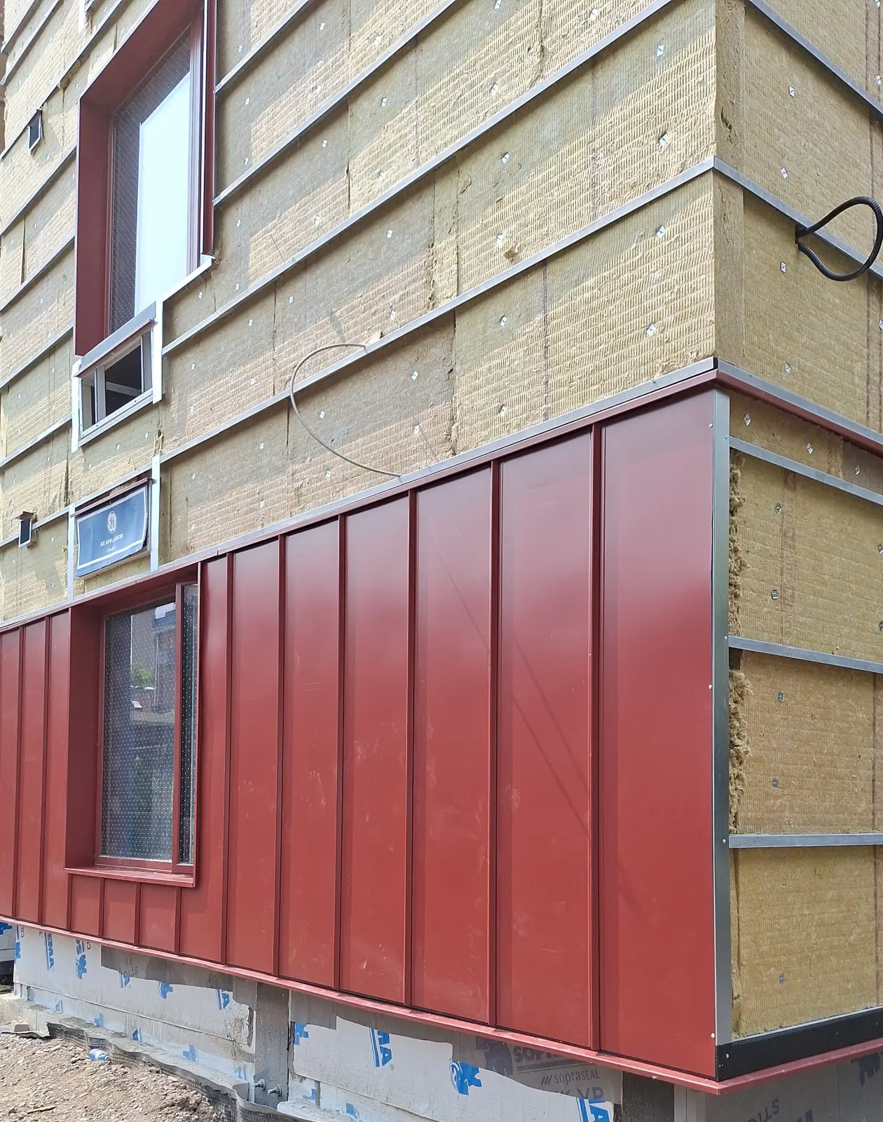 Contemporary building finished with standing seam metal siding, creating a sleek architectural appearance and durable building envelope.