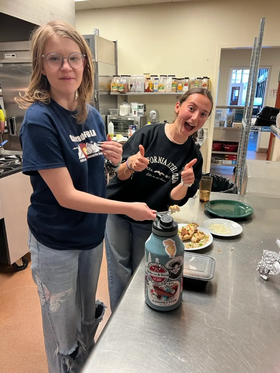 Culinary arts students plating food in the school kitchen