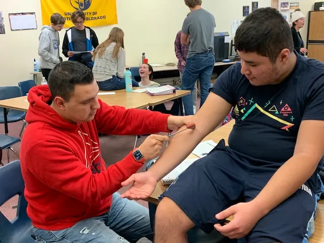 Students practicing clinical skills in a health sciences class