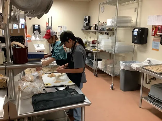 Interns preparing food in a commercial kitchen