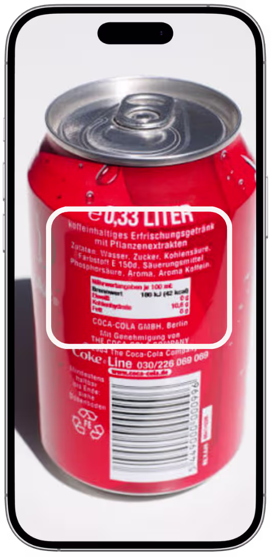 Close-up of a red 0.33 liter soda can showing nutritional and ingredient information on its label.