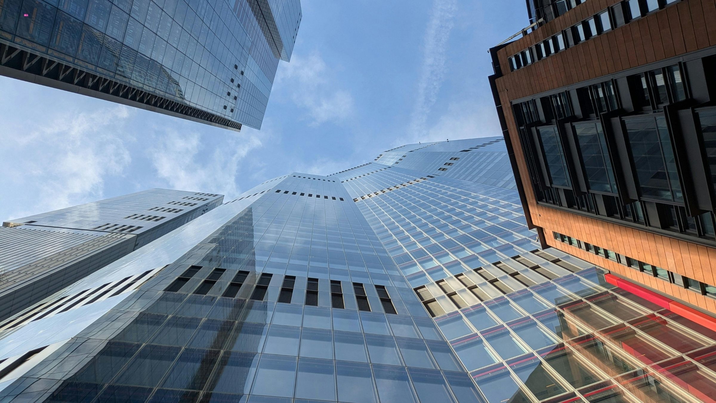 Upward view of glass office buildings against the sky