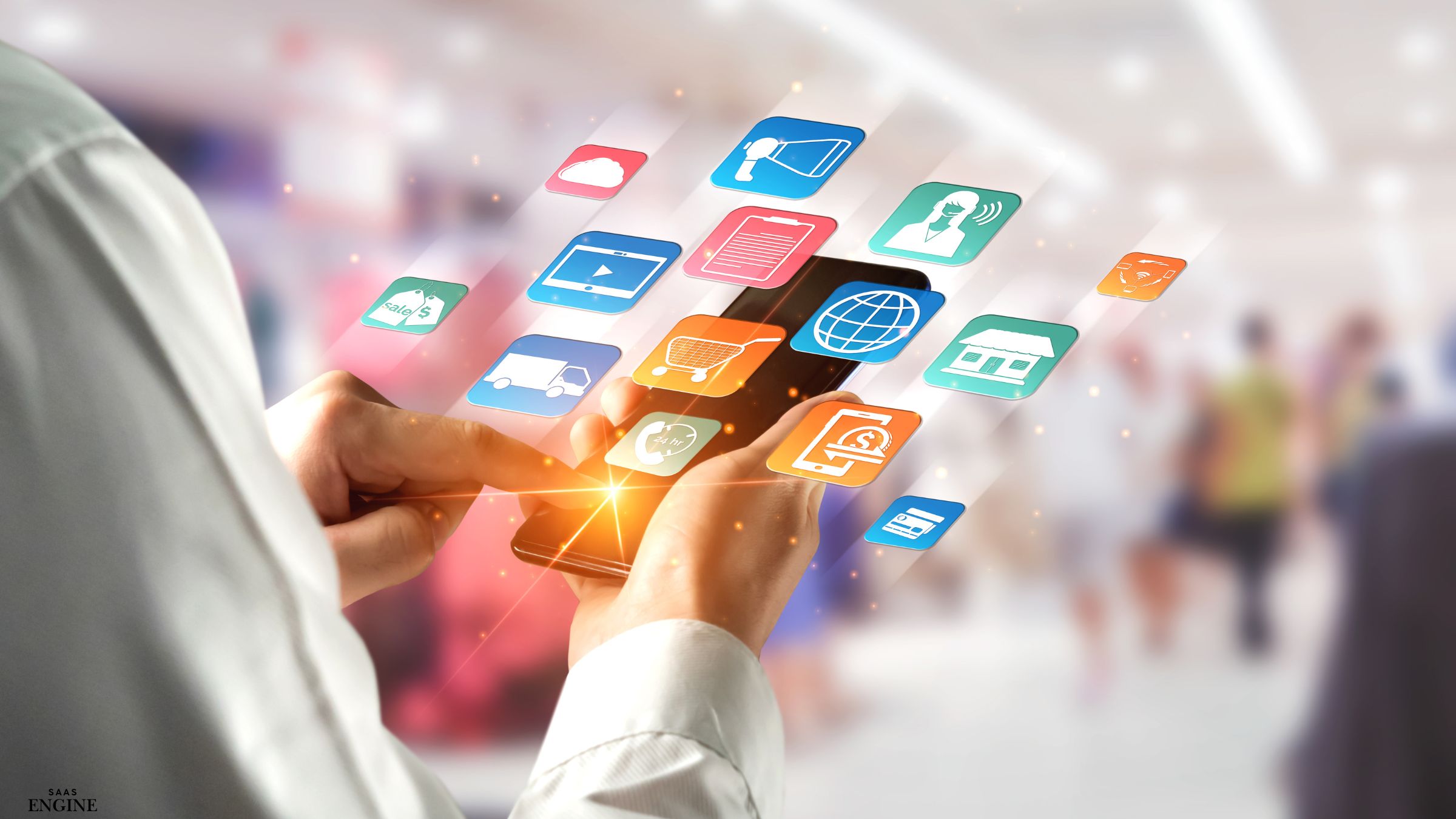 Hand holding a phone with app icons floating above it