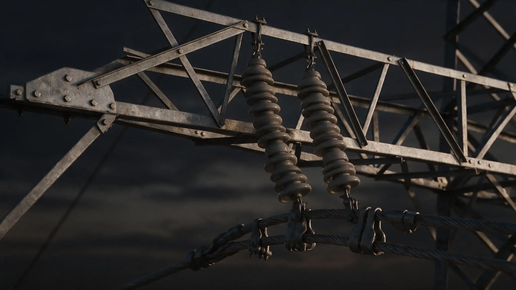 Close-up of two high-voltage insulators attached to metal framework and electrical cables.
