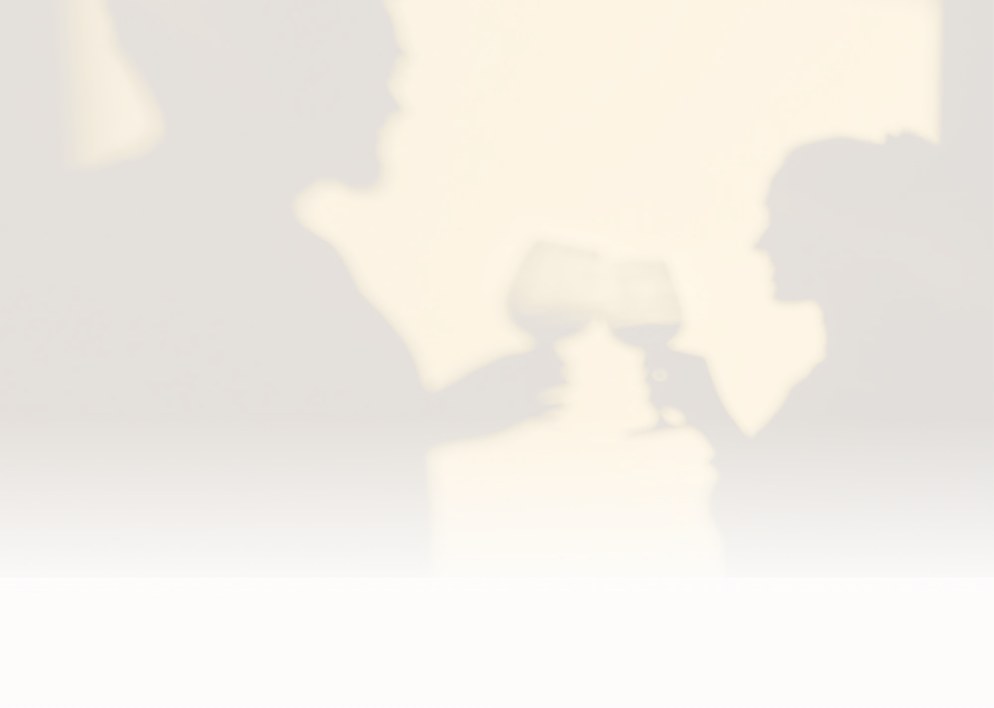 Silhouettes of two people toasting with wine glasses against a warm yellow background.