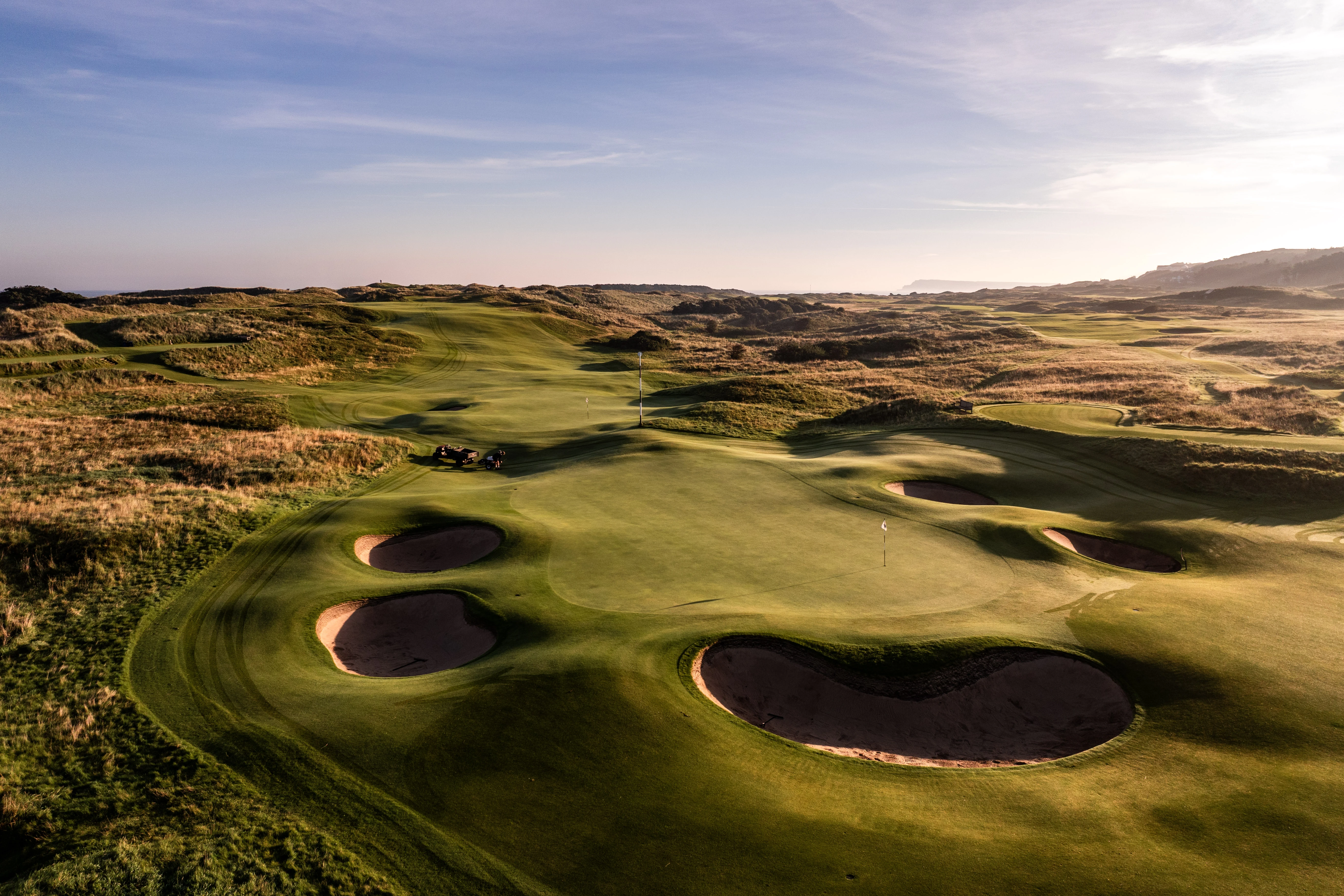 Links course by the sea at sunset