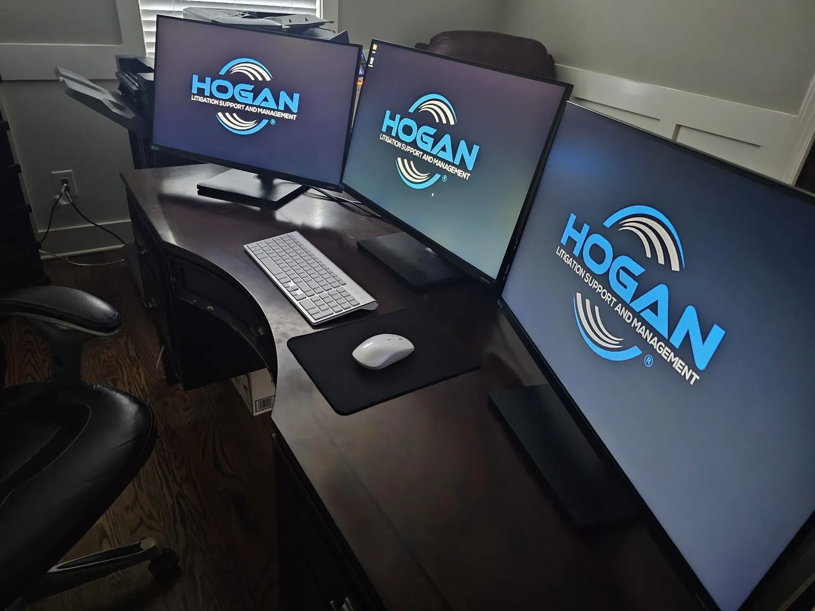 Hogan Corp branded monitors and workstations installed in a trial war room