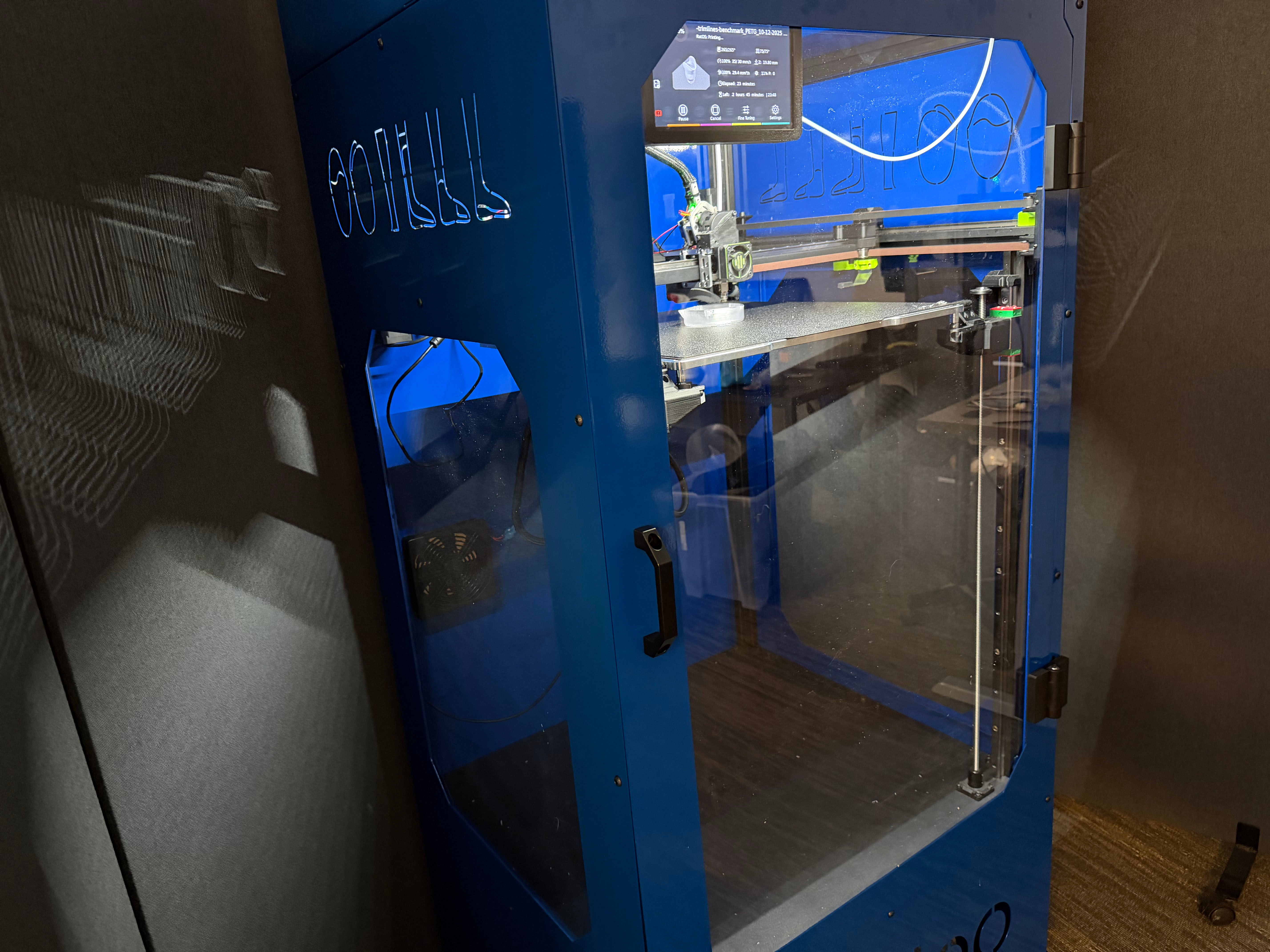 Blue Galileo 3D printer kiosk with a digital control screen and visible print platform inside.