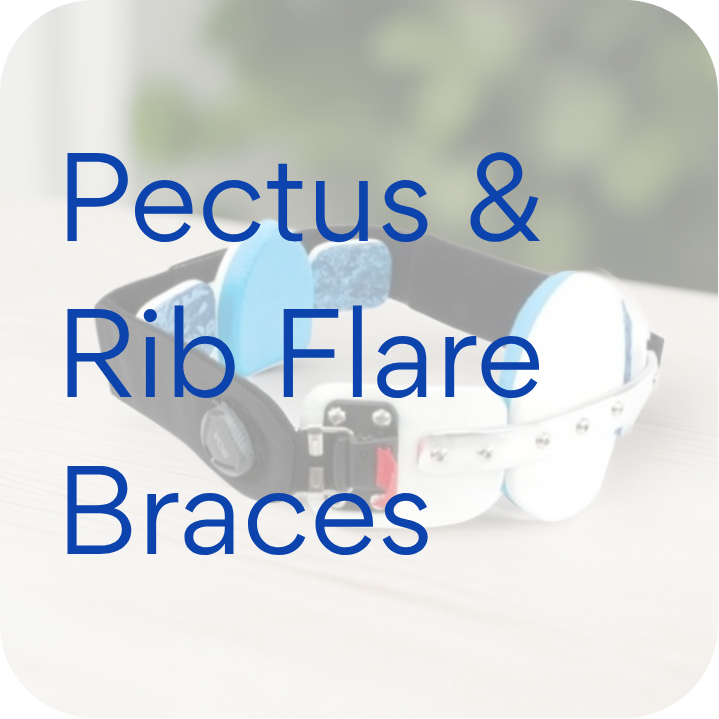 Pectus and rib flare brace with blue and white pads and adjustable black strap on wooden surface.