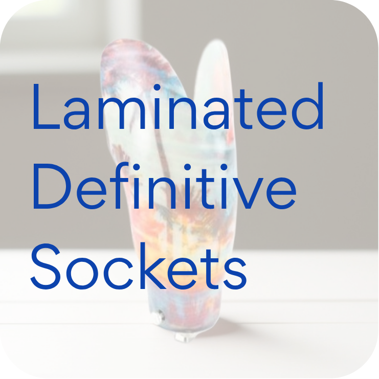 A translucent, colorful laminated definitive socket for prosthetics on a light surface.