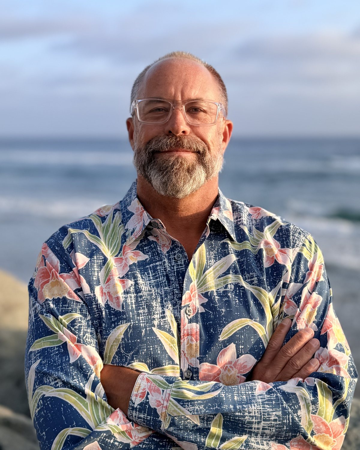 Frank Edsall, III, founder of 10/28 Wealth Management, standing on the Oceanside coastline at sunset
