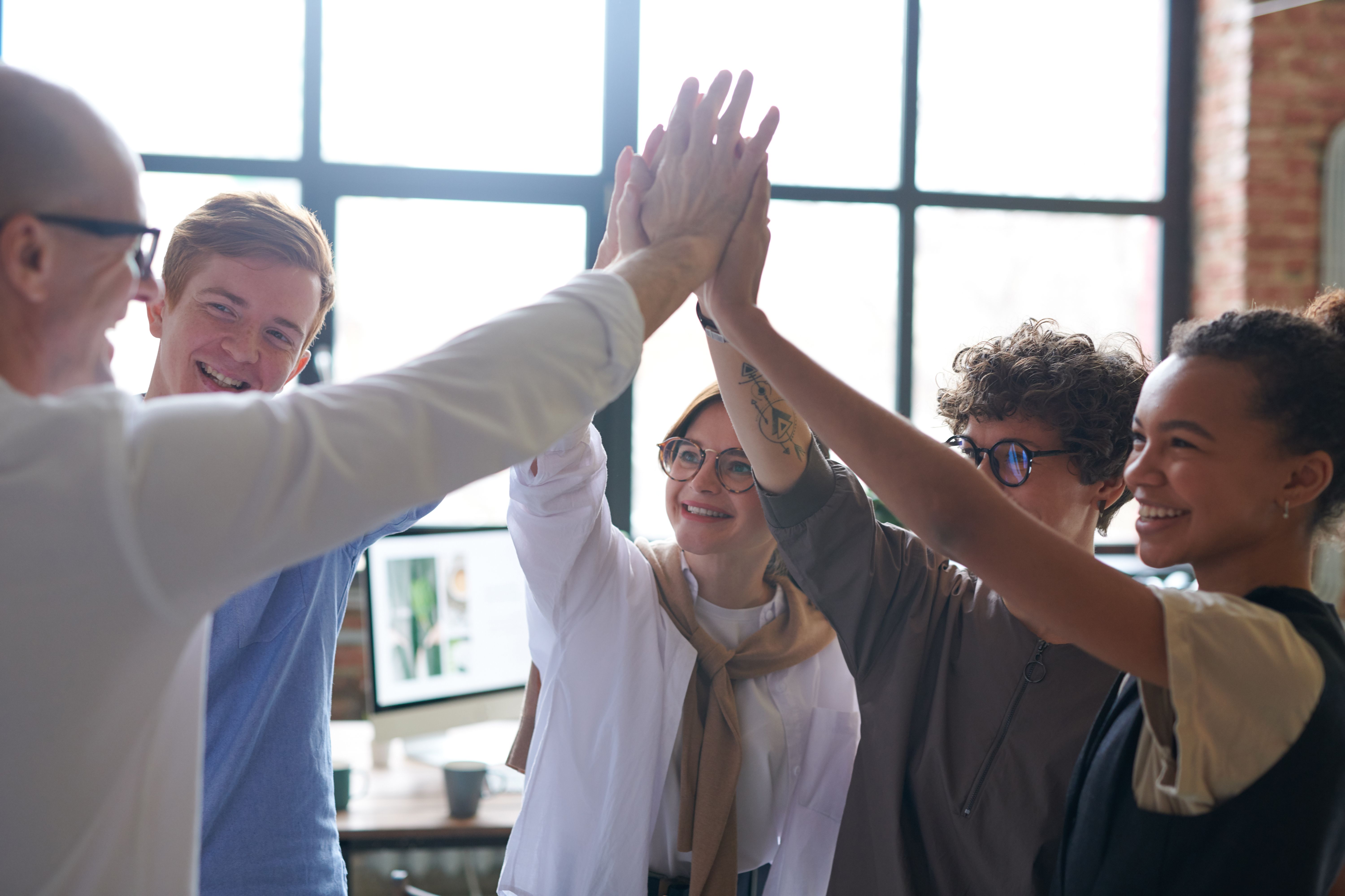 Colleagues standing and talking together near an office window