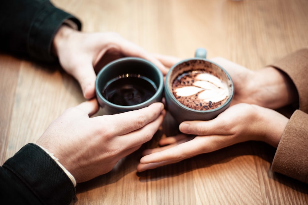 Two people having a relaxed one-on-one conversation over coffee at a table