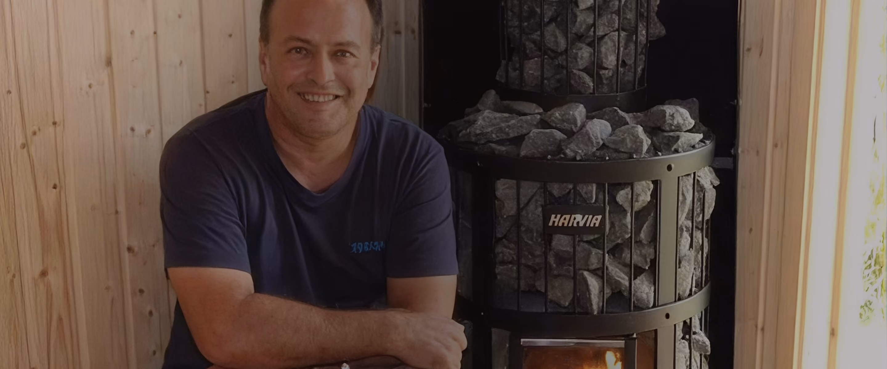 Petri Knuuttila, founder of FinnSauna, beside a sauna heater