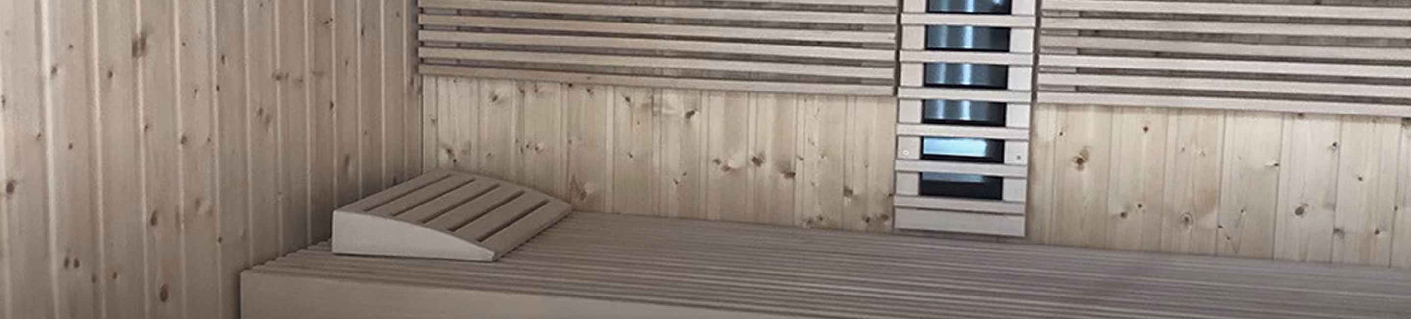 Sauna interior with slatted backrests and infrared panel