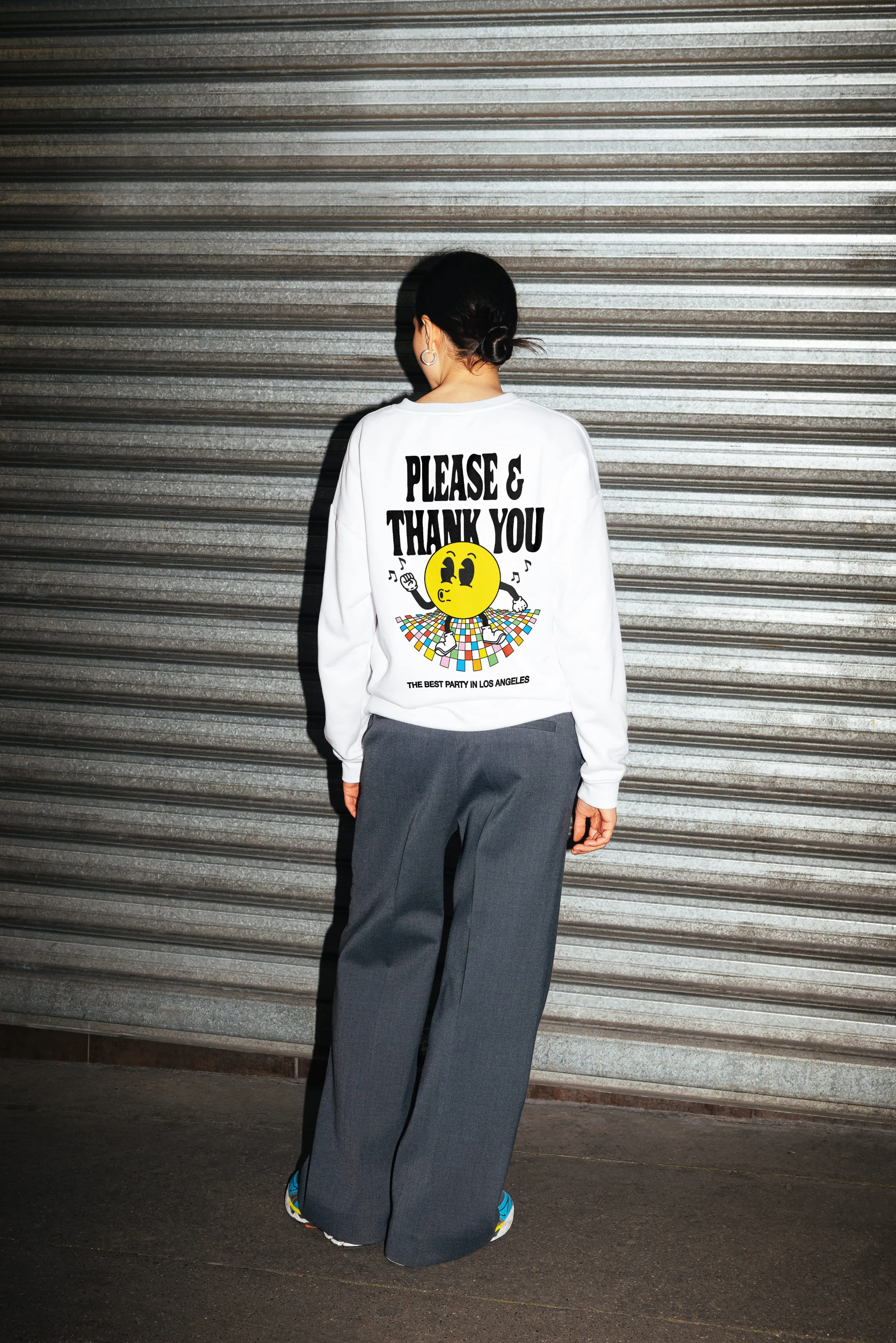 mock up of a person wearing a sweater with a happy face dancing on the back