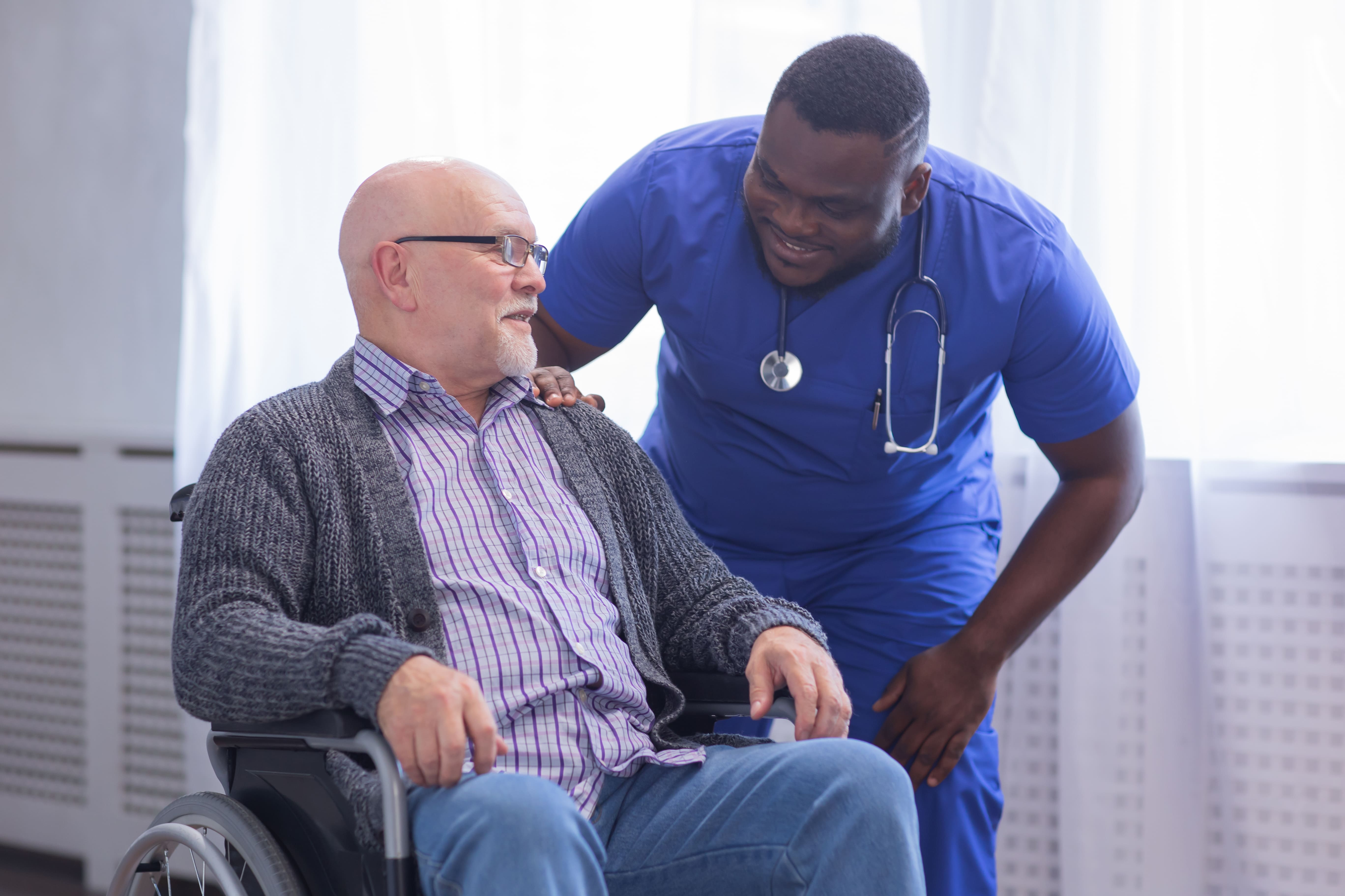 Health and Social Care worker in training caring for a patient on their apprenticeship
