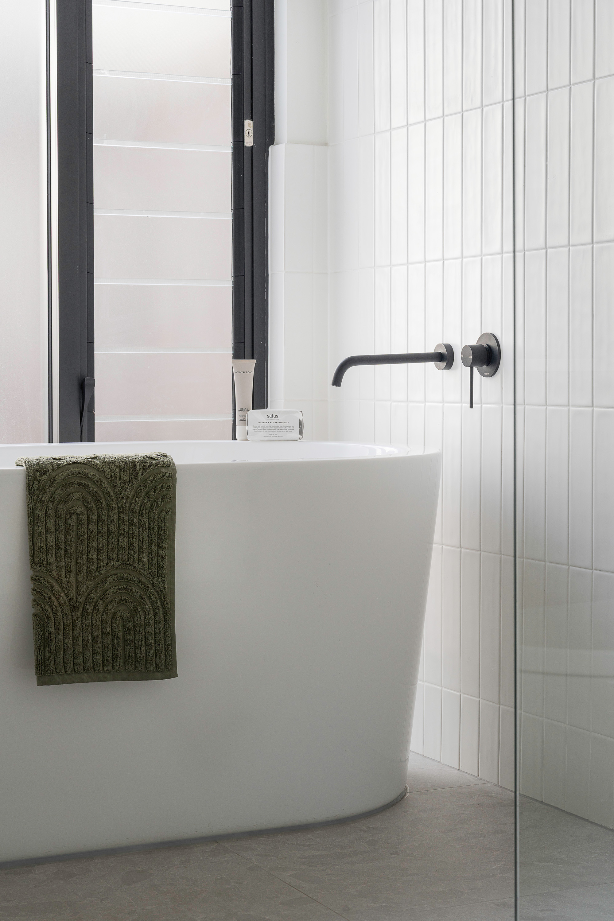 Styled bathroom with freestanding tub and black tapware