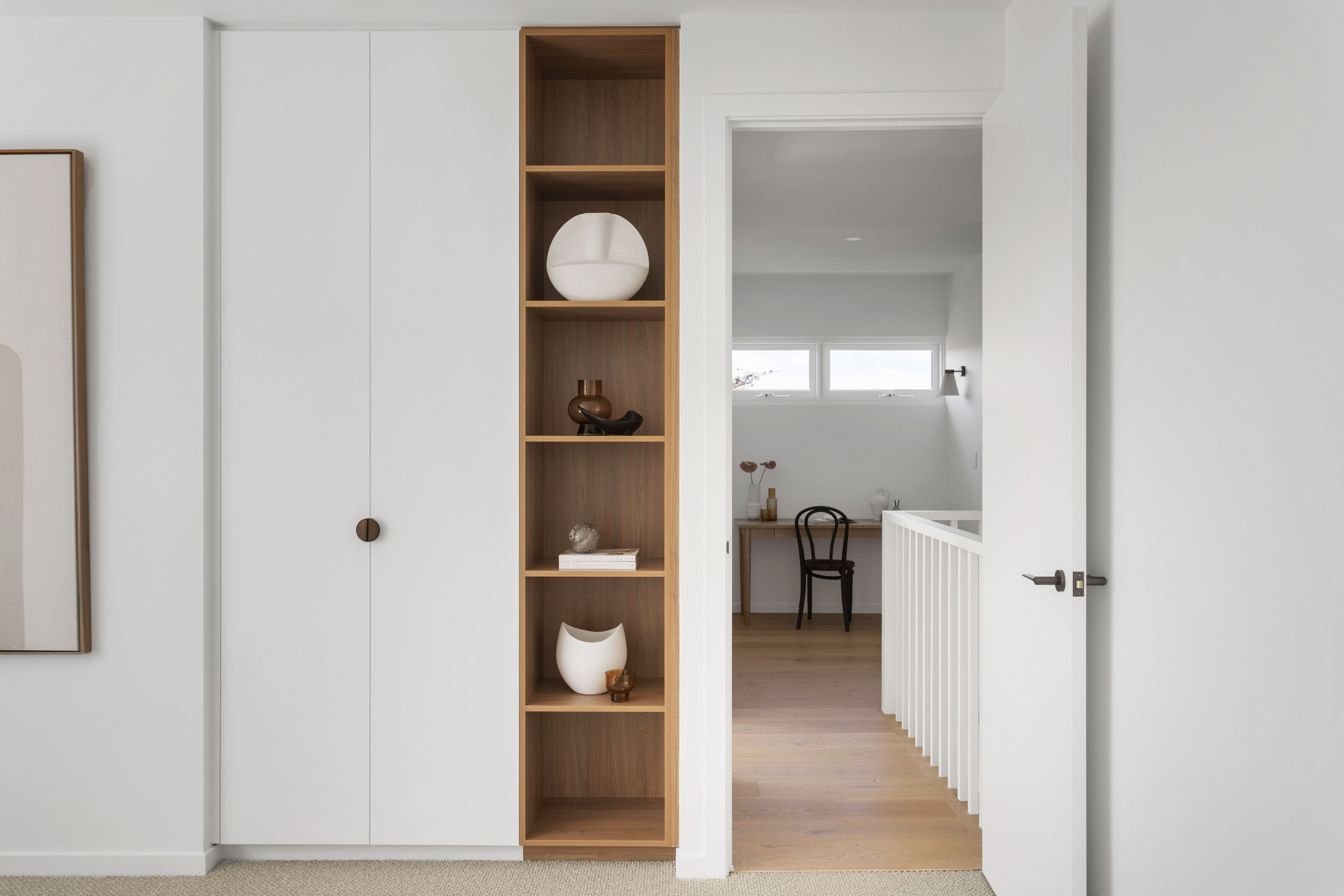 Hallway styled with built-in shelving and display pieces