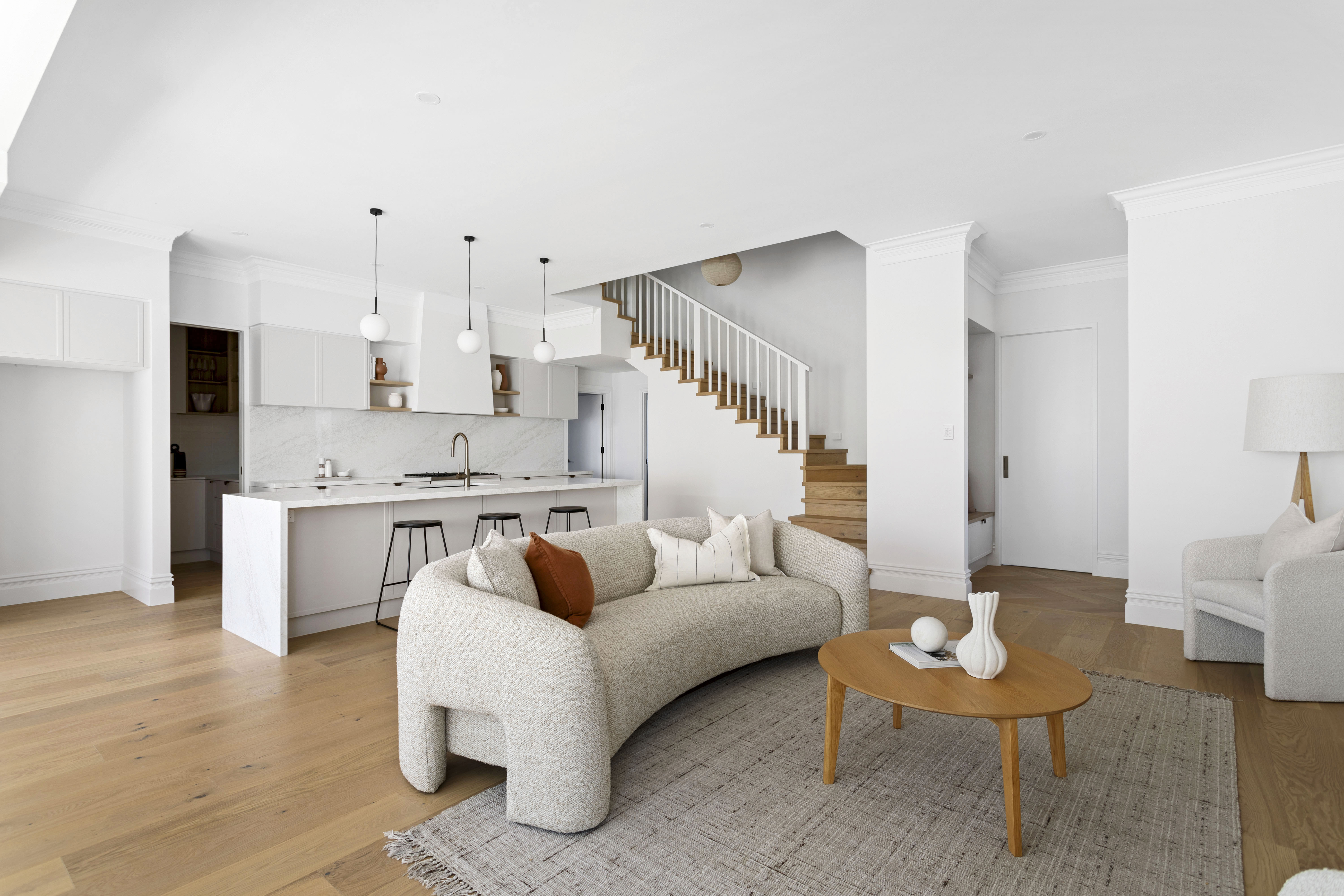 Open-plan kitchen and living area with staircase