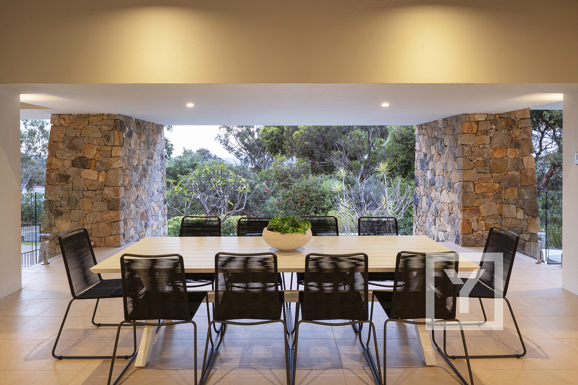 Alfresco dining area styled with stone feature walls