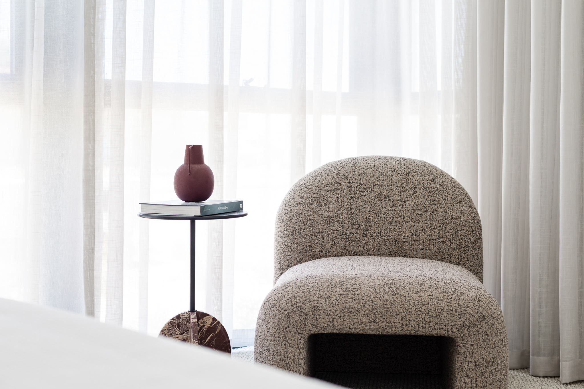 Styled bedroom armchair and side table detail