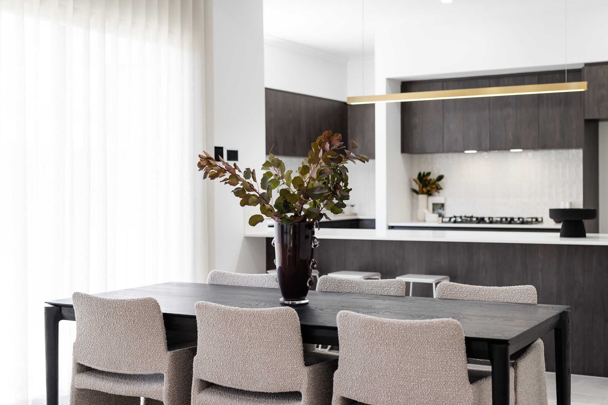 Styled dining table with kitchen in the background
