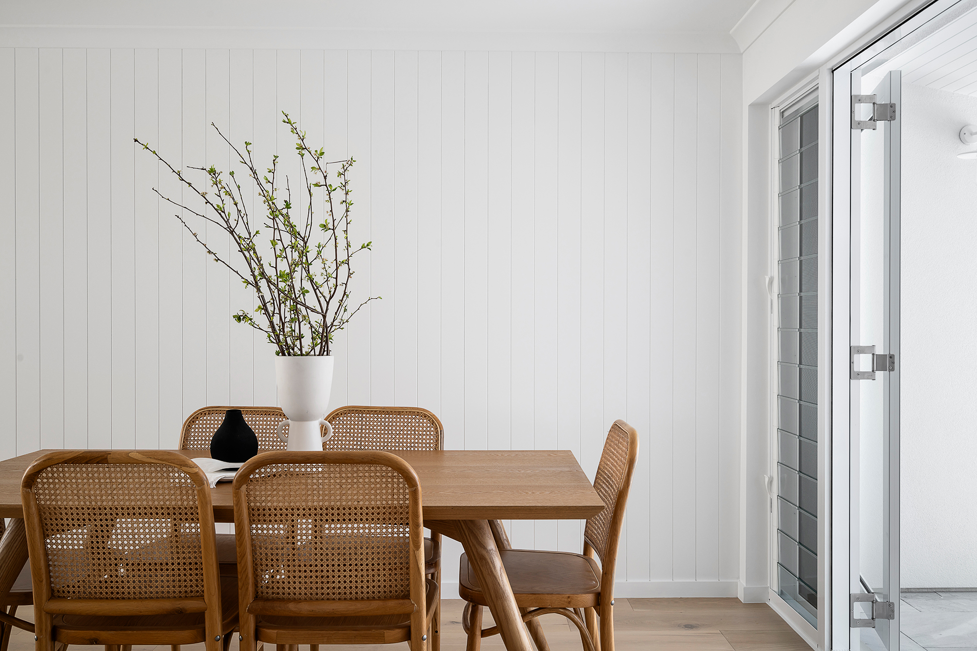 Dining area styled with timber table and cane chairs