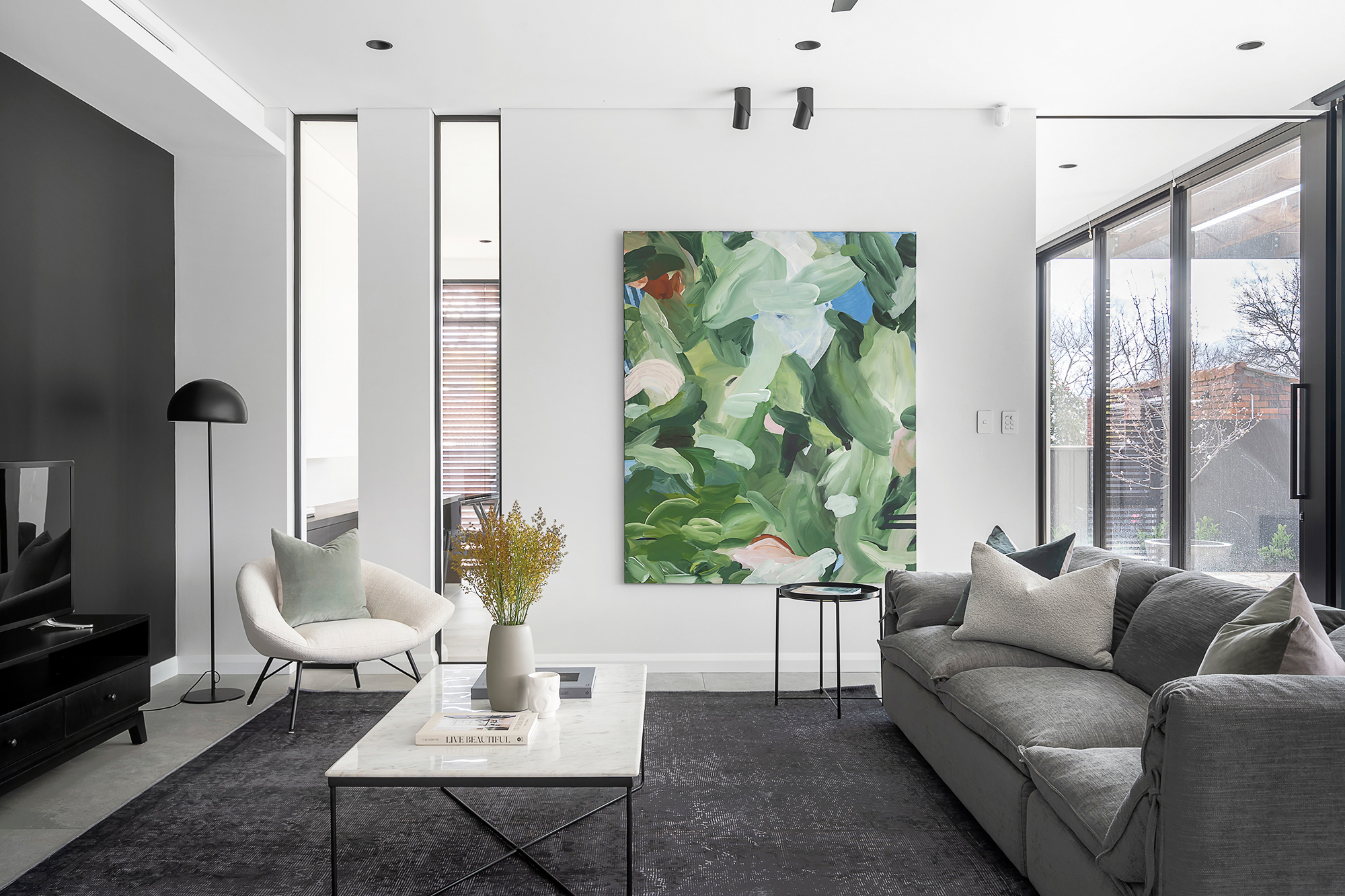 Living room styled with statement artwork and grey sofa
